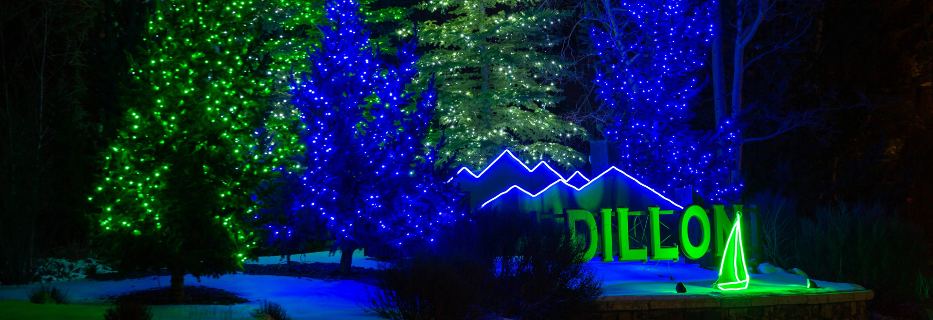 A stunning view of Dillon Colorado's vibrant lights illuminating the night sky.